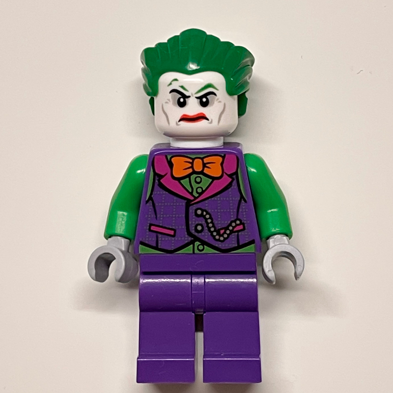 The Joker with Dark Purple Vest Over Green Shirt and Orange Bow Tie