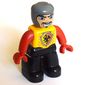 Duplo Figure with Rounded Head with Black Legs, Bright Light Orange Chest, Red Arms and Hands, Wide Crooked Grin