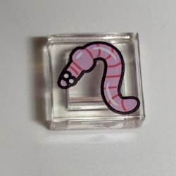 LEGO part 3070bpr9890 Tile 1 x 1 with Pink Worm print in Transparent/ Trans-Clear