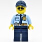 Policeman, Bright Light Blue Shirt with Dark Blue Tie, Badge, and Radio on Belt, Dark Blue Cap, Sunglasses
